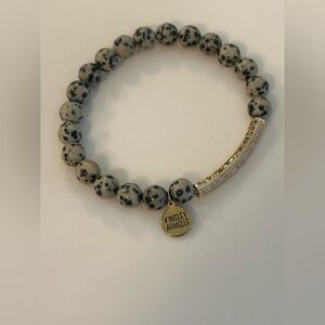 Kinsley Armelle Speckled Stretch Stone Bracelet with a Gold Tone  Design Signed